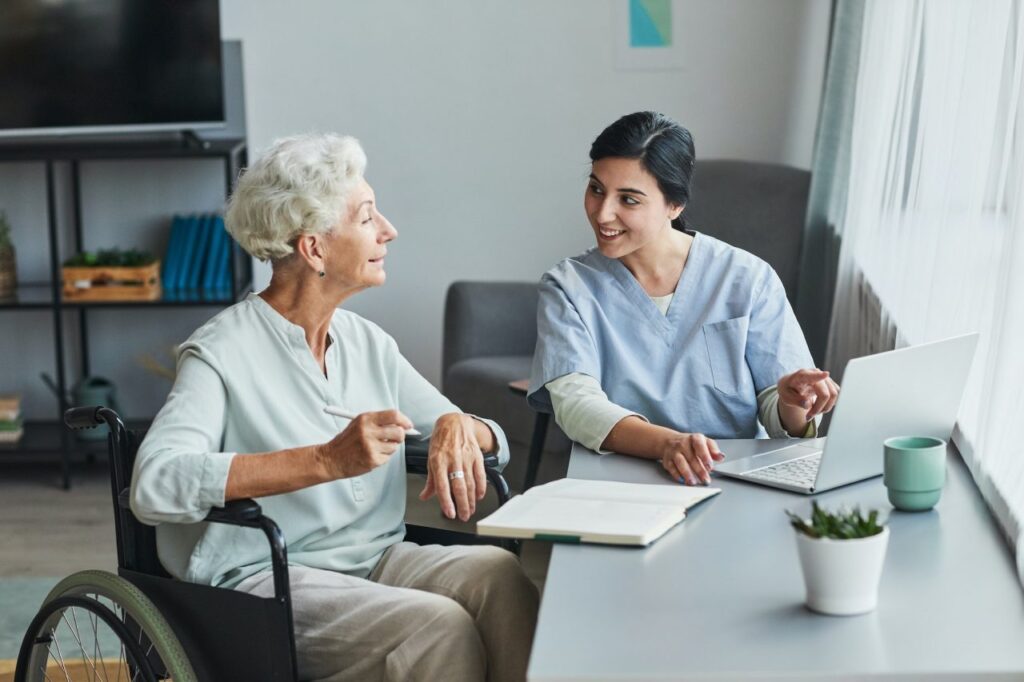 young nurse assisting senior woman